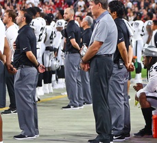 Marshawn Lynch sits during the National Anthem