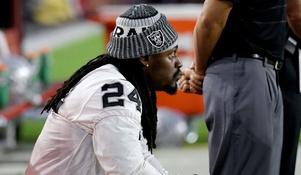 Marshawn Lynch sits for U.S. national anthem, stands for Mexican anthem