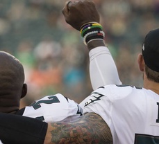 Chris Long shows support for teammate by putting his arm around him during national anthem 